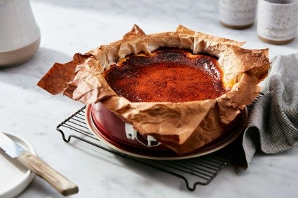 A Basque Cheesecake baked in a springform pan lined with parchment paper
